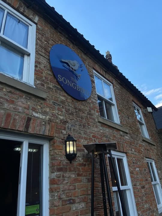The Songbird wall sign